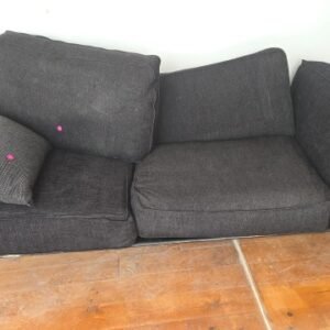 Charcoal - modern dark-grey upholstered sofa features a black metal frame and legs, and includes separate back cushions and a matching throw pillow.